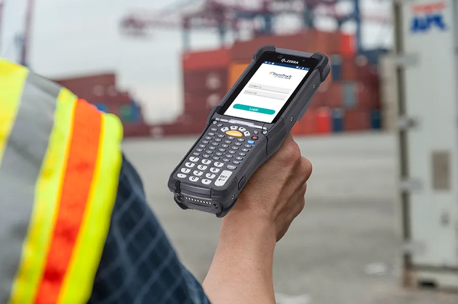 Worker in a safety vest holding a Zebra handheld scanner running the cycle count app